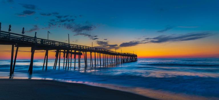 Colorful pre-dawn sky silhouettes the Avon Pier looking north east over the gently lapping Atlantic Ocean